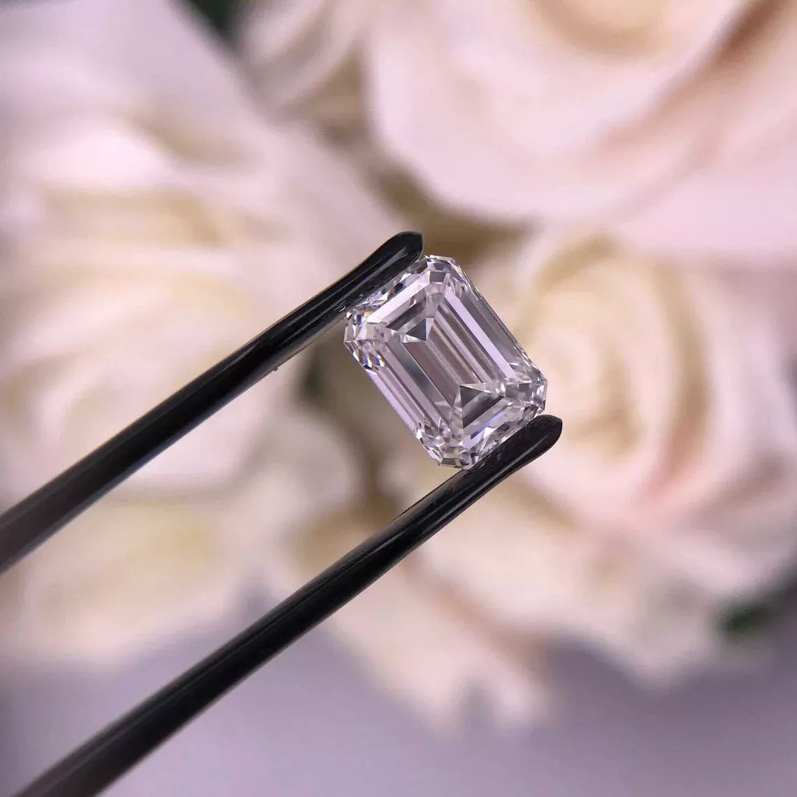 IGI lab diamond, emerald cut, in tweezers focused view.